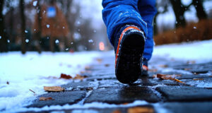 Snow-covered walking path in winter, representing icy sidewalk conditions that cause slip and fall accidents in Minneapolis.