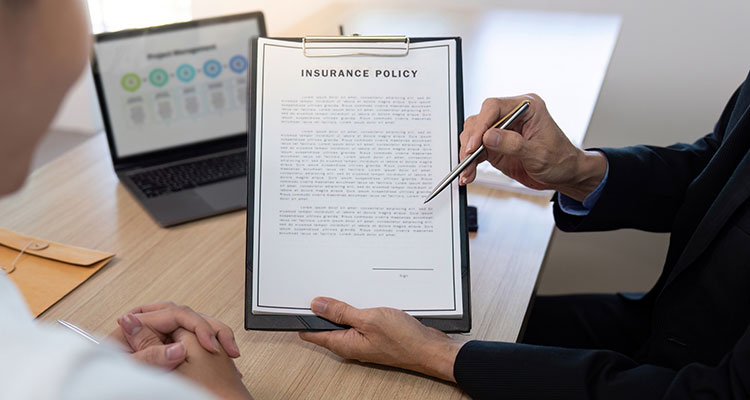 Insurance professional discussing policy details with a client, representing how Minneapolis Uber accident lawyers handle insurance claims after a crash.