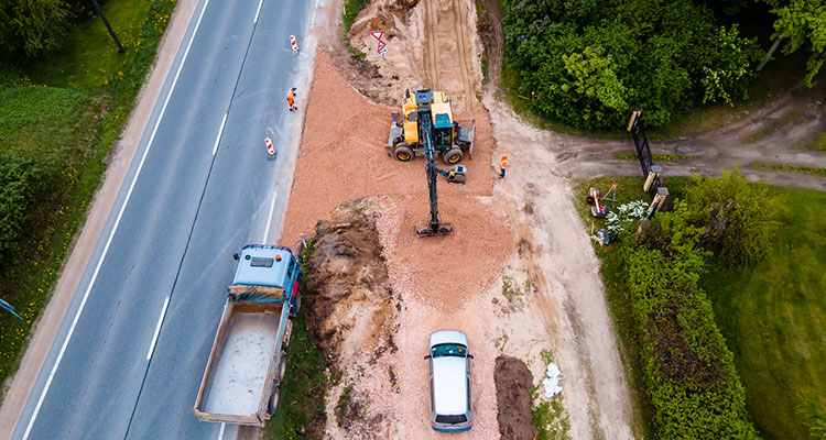Aerial view of a highway work zone with road construction next to a two-lane road, illustrating Minnesota highway work zone accident liability.