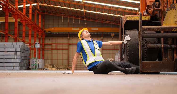 Injured warehouse worker after a forklift accident, illustrating severe workplace injury risks and third-party liability claims.