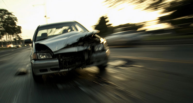 Blurred car in motion on a roadway, illustrating reckless driving behavior such as speeding and unsafe maneuvering that can cause serious St. Paul car accidents.